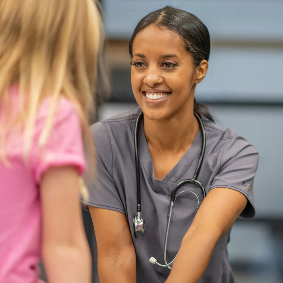 School nurse smiling at child