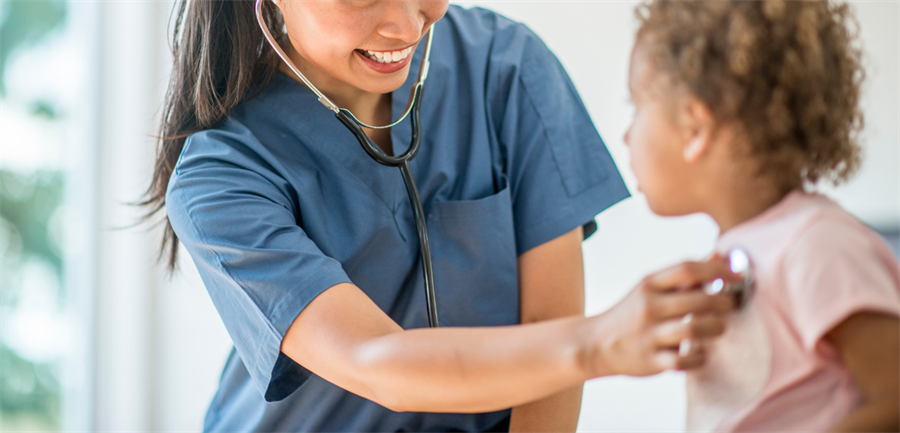 Photo of nurse checking child's lungs with stethoscope