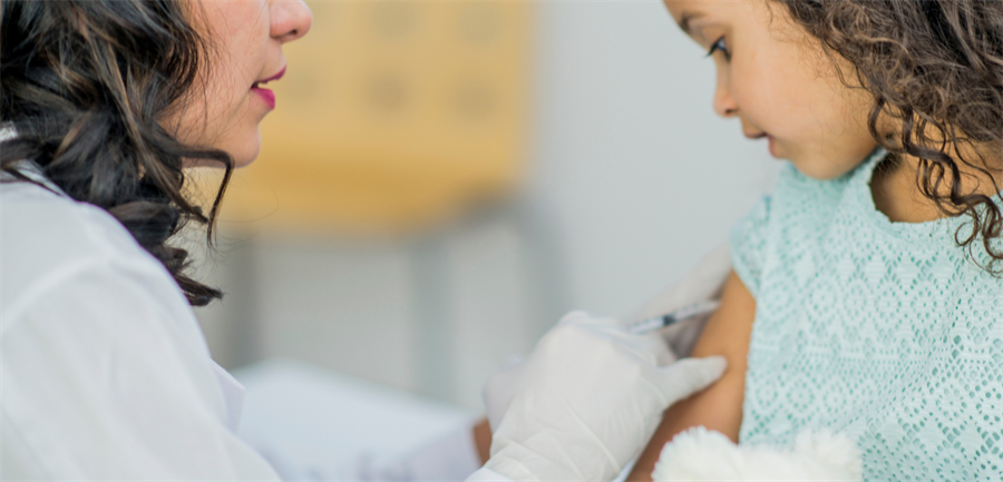 Photo of nurse administering vaccination shot to a child