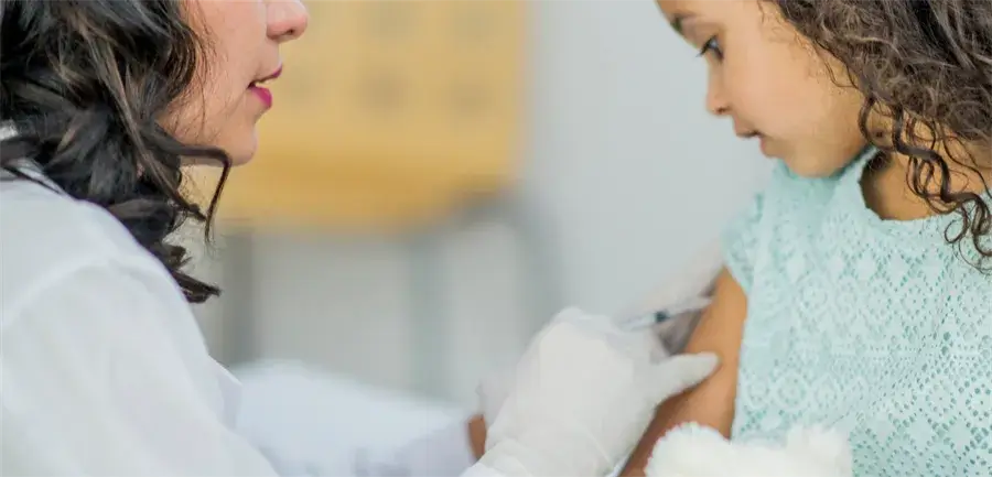 Nurse administering vaccination shot to a child