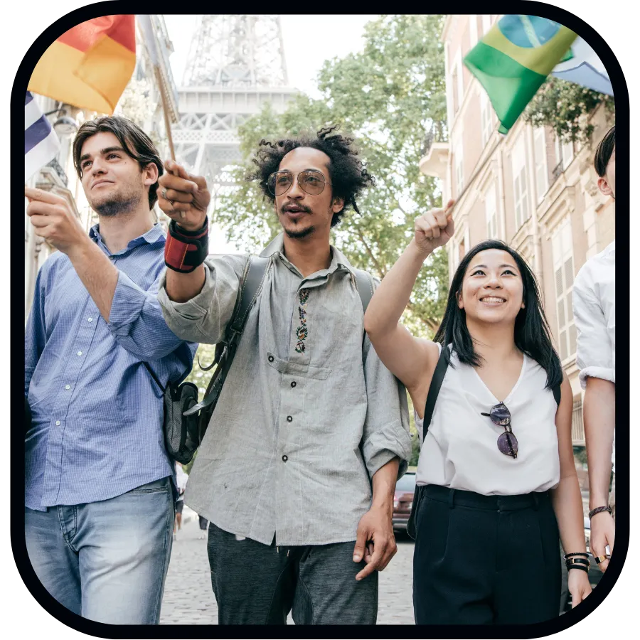 Three people walking with flags from different countries