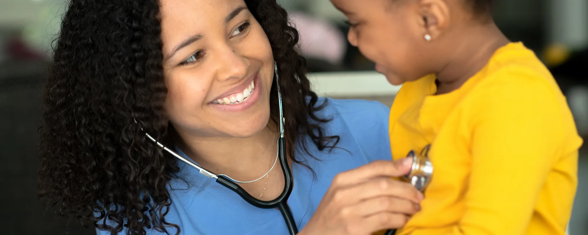 School nurse smiling at young child