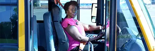 School bus driver seated in the driver seat
